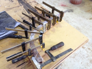Clamps on the thin laminations and an excessive amount of epoxy on all surfaces.