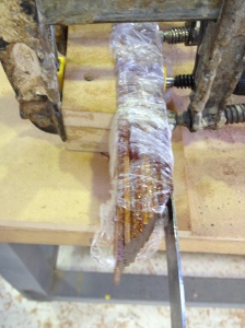 Plastic wrap prevents the laminations from gluing to the mould. Once the inner stems were complete I cleaned them up and used them as moulds for the outer stems. A metal ruler can be seen applied on the outer edge of the stem laminations to prevent wood from splitting when they are bent.